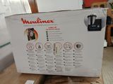 packaging for a coffee maker sitting on top of a box on a table
