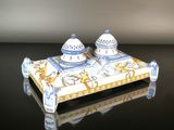 two salt and pepper shakers sitting on a tray