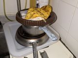 a bowl of bananas sitting on top of a stove