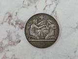 a close up of a silver coin on a marble surface
