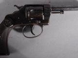 an old gun with a wooden handle on a white surface