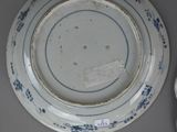 two plates and a bowl sitting on a table