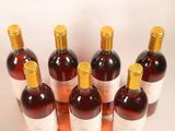 several bottles of wine are lined up on a table
