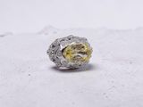 an image of a yellow diamond ring sitting on top of a white surface