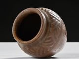 a brown vase sitting on a white table
