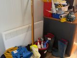 a pile of clothes on the floor next to a radiator