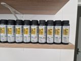 a shelf that has a bunch of ink bottles on it