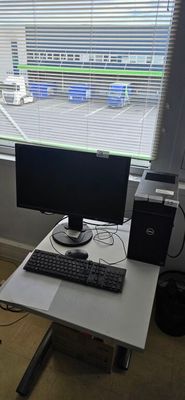 a desk with a computer monitor and keyboard on it