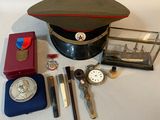 a hat, watch, keys, and other items on a table