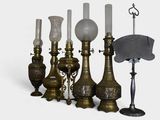 a lot of antique lamps and a hat on the table