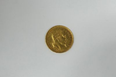 a close up of a gold coin on a white surface