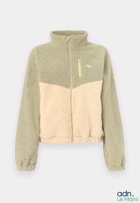 une veste pour femme avec un motif color block vert et beige sur le devant