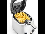 a close up of a fryer with french fries in it
