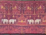 an image of a red cloth with elephants on it sitting on a chair