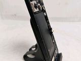 a close up of a cell phone on a stand on a white surface