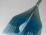 a blue glass sculpture of a plane on a white surface