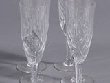 three clear wine glasses sitting on top of a table next to each other