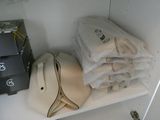 a hat and a bag on a shelf in a closet