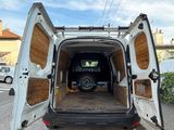 a white van that is parked on the side of the street