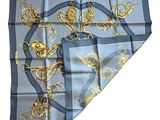 blue and gold silk scarf with a design of lions and chains on it