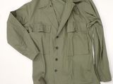 an olive green military jacket with buttons and buttons on the chest