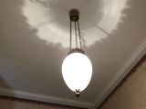 a light that is hanging from the ceiling in the bathroom