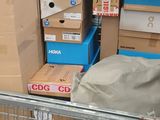 a shopping cart in the middle of a store filled with boxes