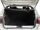 the back of a white car with its trunk open showing the trunk space