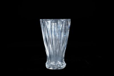 a glass vase that is sitting on a black surface