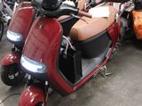 many scooters that are parked in a garage