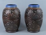 two vases sitting side by side on a gray surface