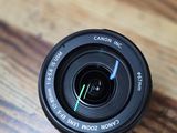 a camera lens that is sitting on a wooden table