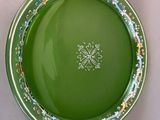 a green plate with a floral design on it