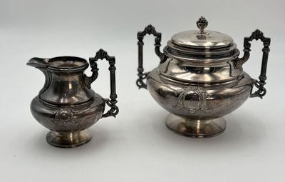 pair of antique silver plated teapots with handles and handles