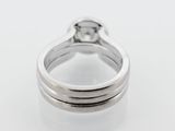 a close up of a diamond ring on a white surface