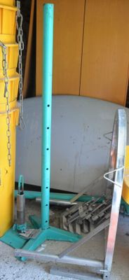 a yellow bucket sitting next to a white tub