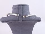 a close up of two silver rings on a mannequin neck