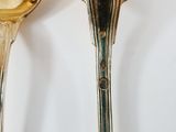 two spoons that are sitting next to each other on a table