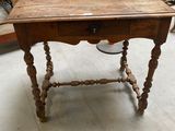 a wooden table with a drawer on top of it