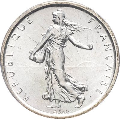 an image of a silver coin with a woman walking on it