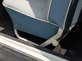 a blue suitcase sitting in the back of a van