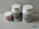 two bottles of whey and one bottle of whey sitting on a counter