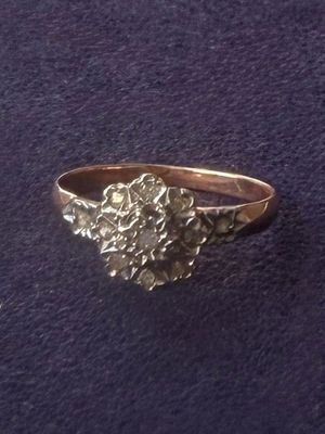 a close up of a silver ring on a purple surface