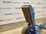 a blue hand truck with a wooden block attached to it