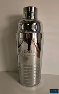 a silver cocktail shaker sitting on a table