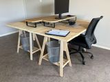 a desk with a computer and a chair in the room