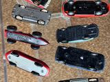 many different types of toy cars on display in a display case