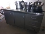 pots and pans sit on top of a stainless steel counter top