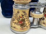 a pair of antique salt and pepper shakers on a table