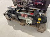an image of a winch sitting on top of a wooden pallet